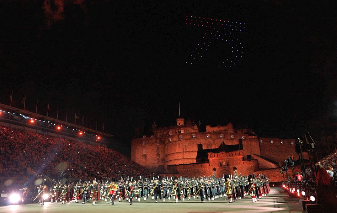 Edinburgh castle at night with performers in the foreground
